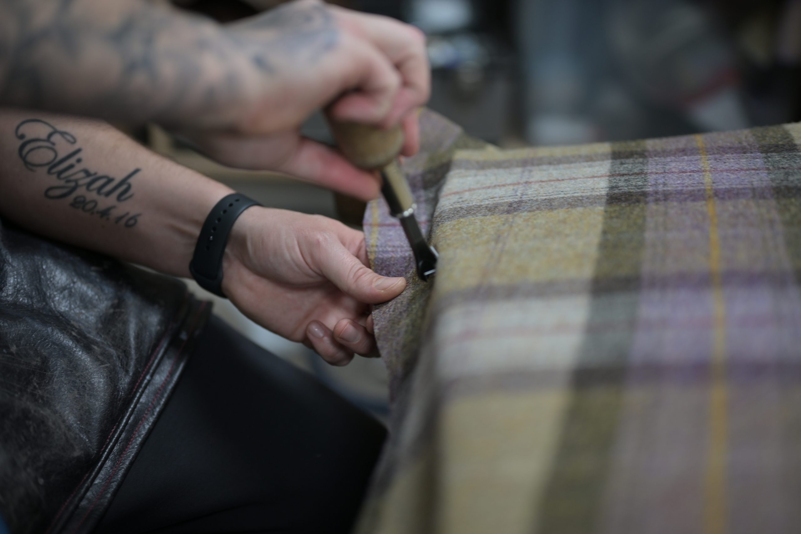 Fabric being cut precisely by hand