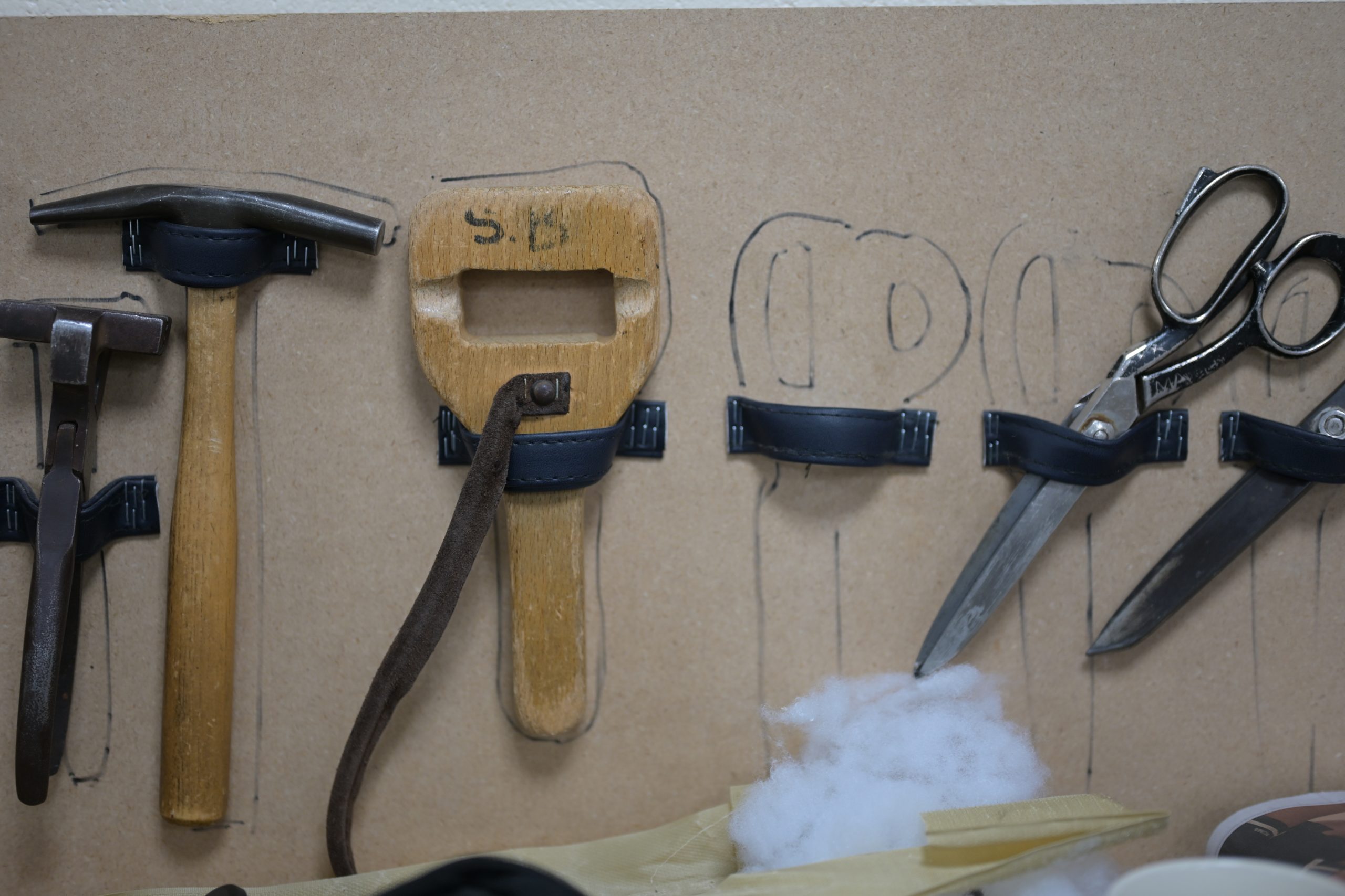 Traditional upholstery tools on a workshop bench