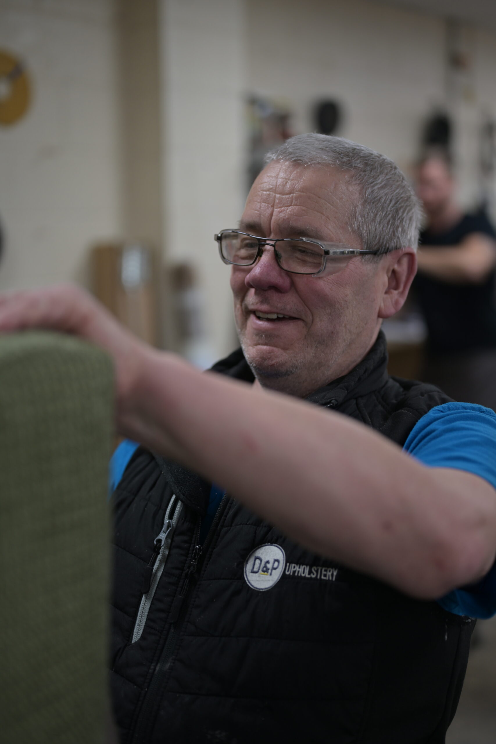 Steve carefully working on an upholstered chair